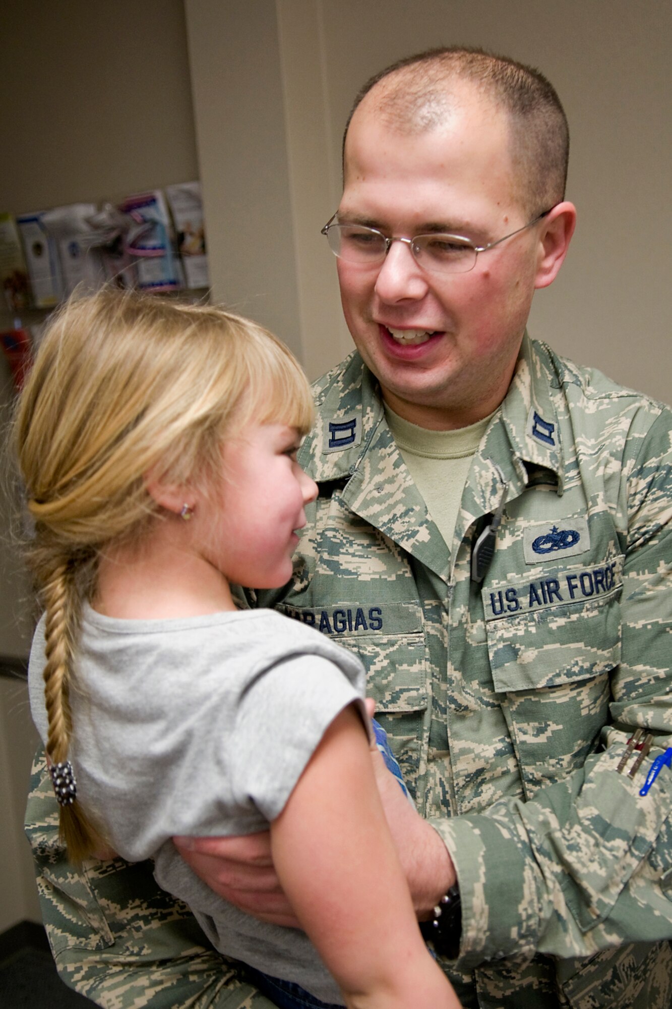 Capt. Theodore Karagias, 434th Aircraft Maintenance Squadron maintenance officer, spends a moment with his 5-year-old daughter, Addison, after returning from a deployment at Grissom Air Reserve Base, Ind., Jan. 20, 2014. Karagias and 19 other 434th Air Refueling Wing Airmen returned to Grissom after spending several months at Al Udeid Air Base, Qatar. (U.S. Air Force photo/Tech. Sgt. Mark R. W. Orders-Woempner) 
