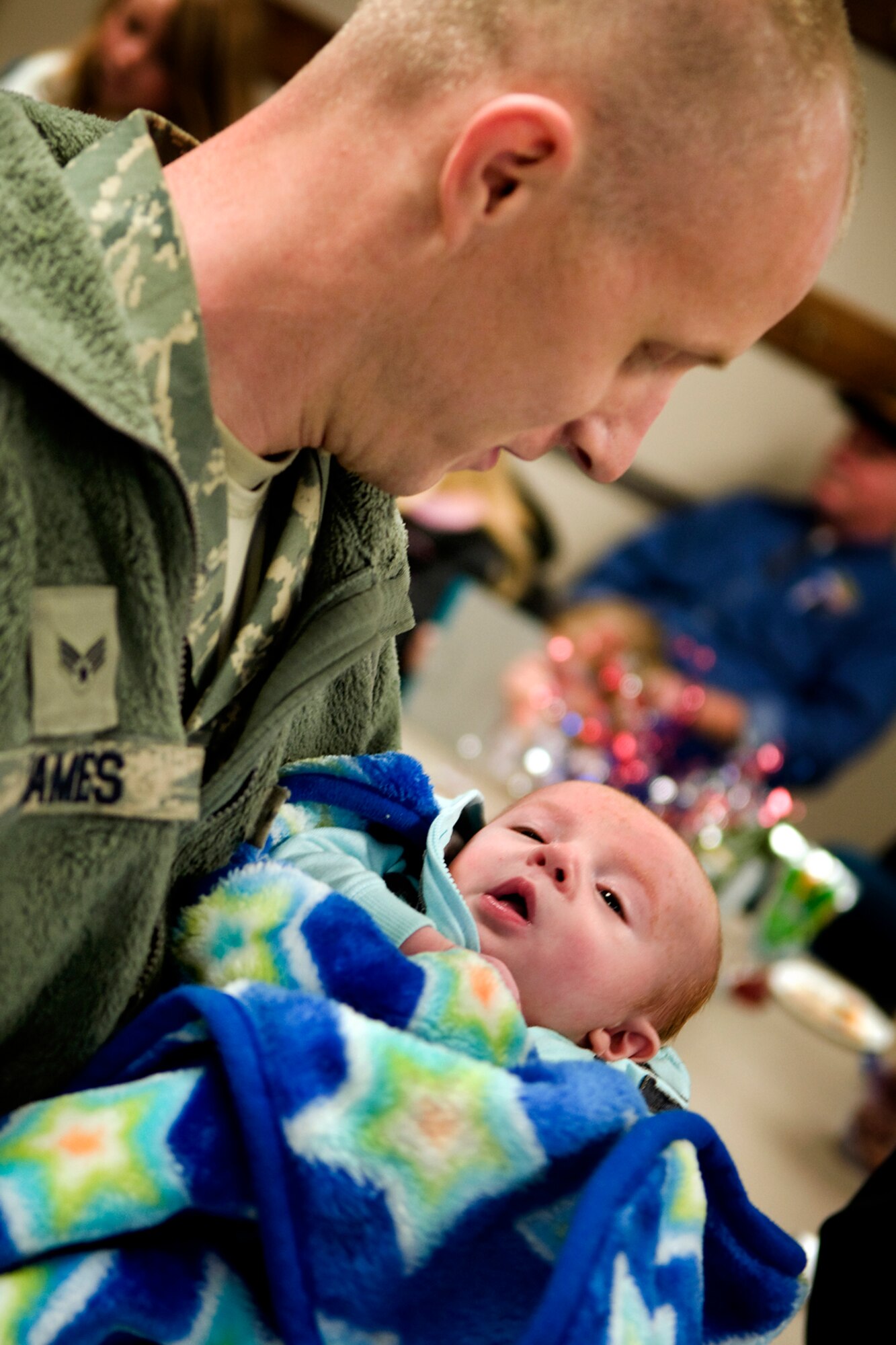 Senior Airman Chad James, 434th Maintenance Squadron aerospace ground equipment specialist holds his new son, Oakley, for the first time after returning from a deployment at Grissom Air Reserve Base, Ind., Jan. 20, 2014. James and his wife, Kaylee, planned on using mobile video messaging for him to be in the delivery room when Oakley was born; however, an Internet outage at the deployed location prevented him from seeing his newborn until an hour-and-a-half after the birth. (U.S. Air Force photo/Tech. Sgt. Mark R. W. Orders-Woempner) 
