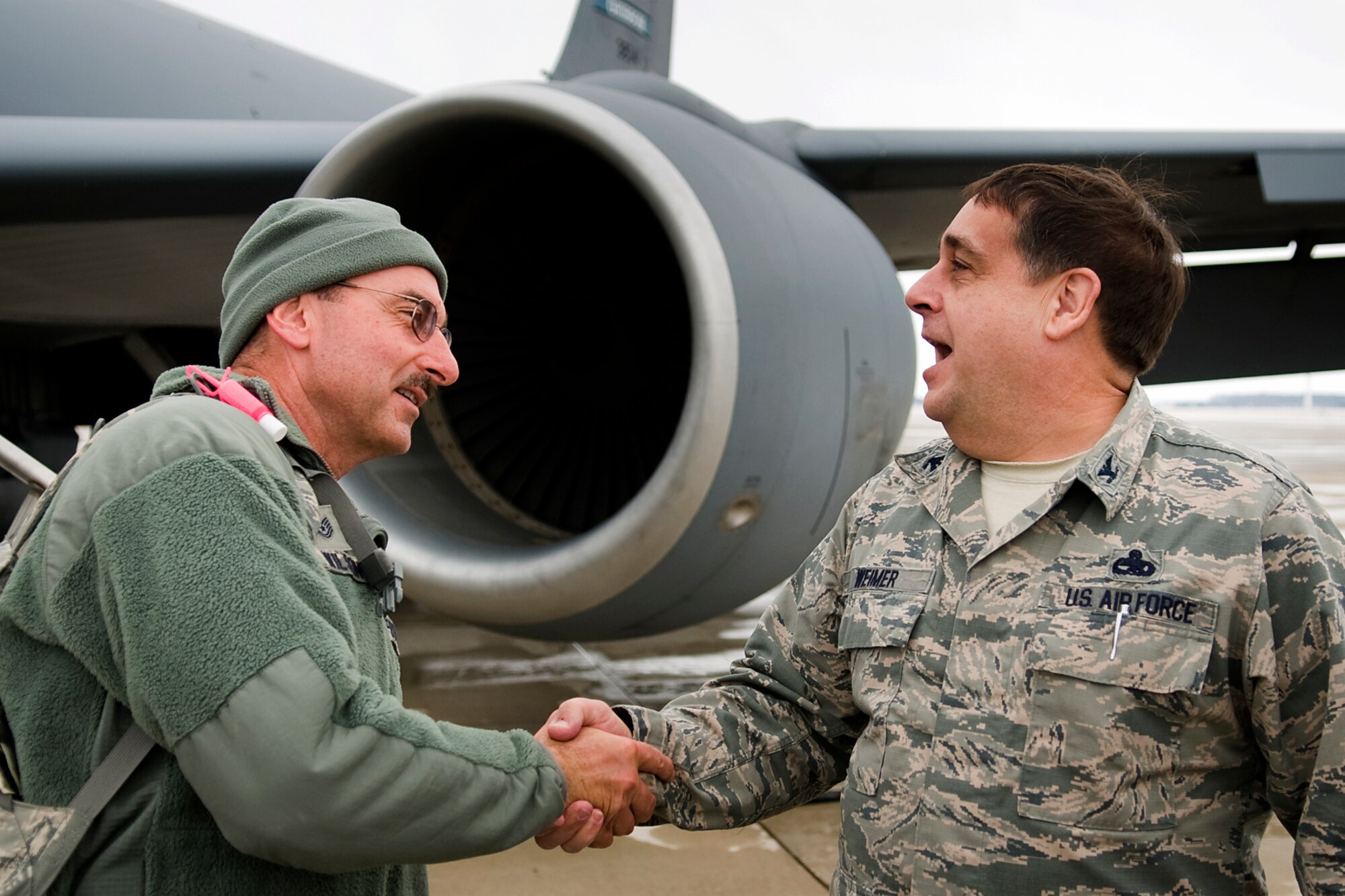 Col. Paul Weimer, 434th Maintenance Group commander, right, greets Tech. Sgt. Mark Wilson, 434th MXG quality assurance technician, after Wilson returned from a deployment at Grissom Air Reserve Base, Ind., Jan. 20, 2014. Twenty 434th Air Refueling Wing Airmen returned to Grissom, completing a deployment cycle to Al Udeid Air Base, Qatar, that began in May 2013 that included 138 Airmen deploying during that time. (U.S. Air Force photo/Tech. Sgt. Mark R. W. Orders-Woempner) 
