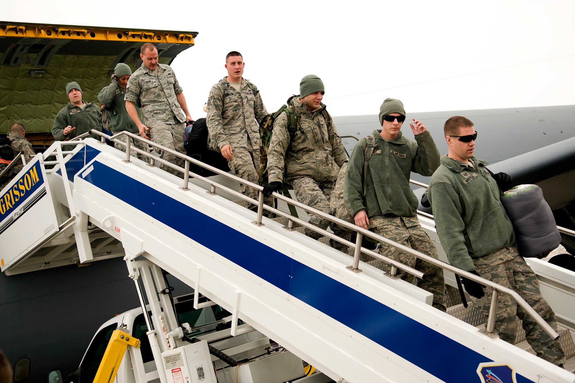 Airmen from the 434th Air Refueling Wing step off a KC-135R Stratotanker onto U.S. soil for the first time in several months after returning from a deployment at Grissom Air Reserve Base, Ind., Jan. 20, 2014. Twenty Airmen returned to Grissom, completing a deployment cycle to Al Udeid Air Base, Qatar, that began in May 2013 that included 138 Airmen deploying during that time. (U.S. Air Force photo/Tech. Sgt. Mark R. W. Orders-Woempner) 
