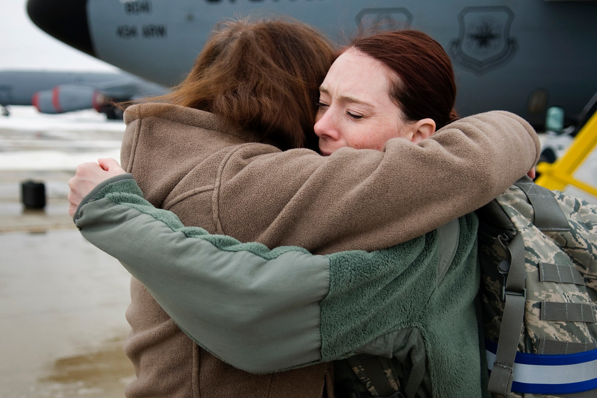 Tech. Sgt. Dominique Ortiz, 434th Operations Support Squadron intelligence technician, right, is greeted by her mother, Diana O'Brien, 434th Logistics Readiness Squadron transportation quality assurance evaluator, after returning from a deployment at Grissom Air Reserve Base, Ind., Jan. 20, 2014. Ortiz and 19 other 434th Air Refueling Wing Airmen returned to Grissom after spending several months at Al Udeid Air Base, Qatar. (U.S. Air Force photo/Tech. Sgt. Mark R. W. Orders-Woempner) 
