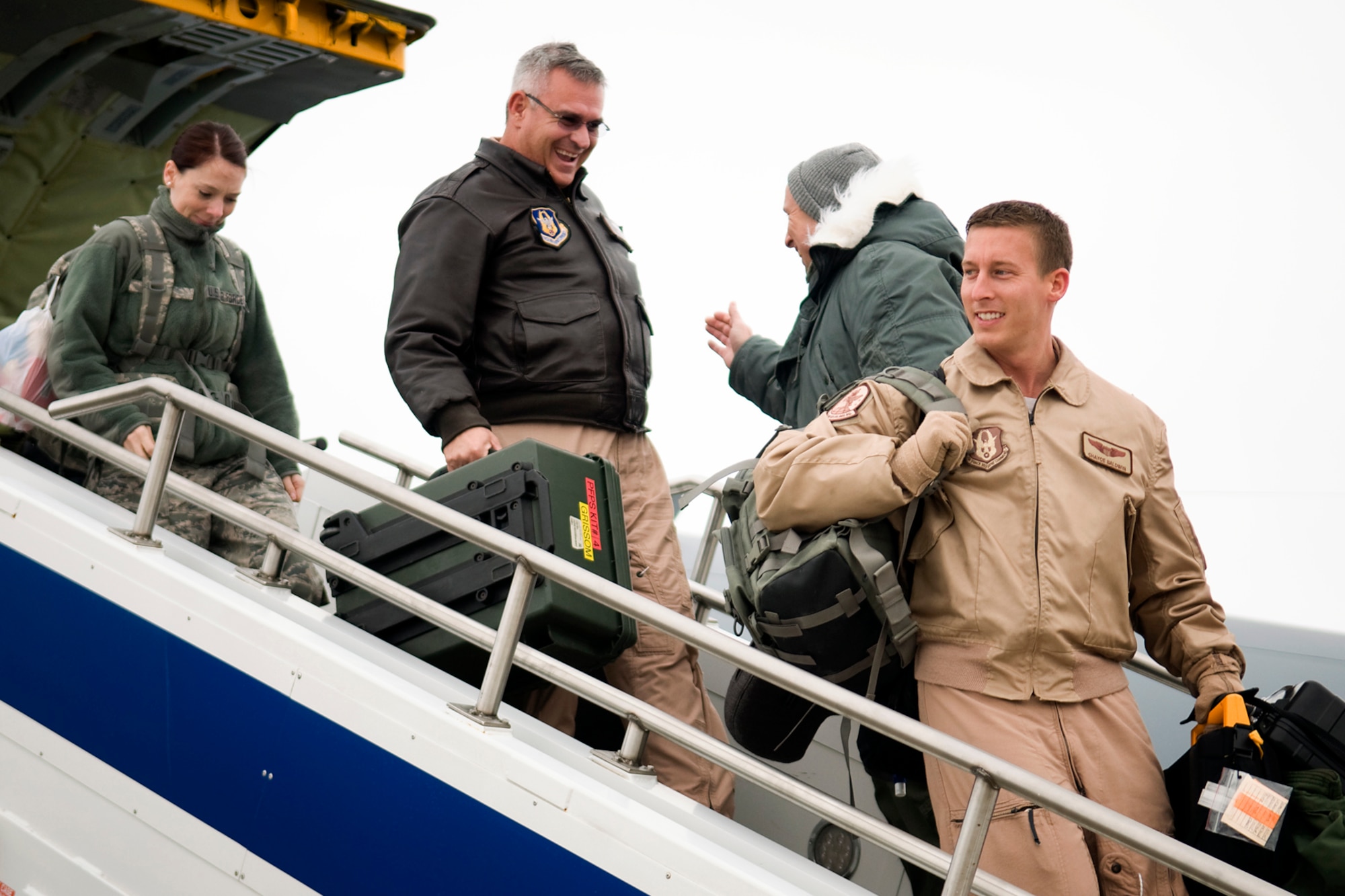 Capt. Chayce Baldwin, 72nd Air Refueling Squadron aircraft commander, leads the way as he, Lt. Col. John Pannell, 74th Air Refueling Squadron chief pilot, and Tech. Sgt. Dominique Ortiz, 434th Operations Support Squadron intelligence technician, deplane a KC-135R Stratotanker after returning from a deployment at Grissom Air Reserve Base, Ind., Jan. 20, 2014. Twenty 434th Air Refueling Wing Airmen returned to Grissom after spending several months at Al Udeid Air Base, Qatar. (U.S. Air Force photo/Tech. Sgt. Mark R. W. Orders-Woempner) 
