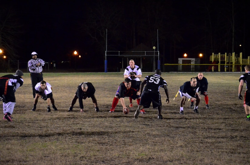 The 628th Civil Engineer Squadron prepares for an offensive play during the Flag Football Championship, Jan. 17, 2014 at Joint Base Charleston – Air Base, S.C. CES beat the 628th Force Support Squadron 13-12 to win back-to-back championships. (U.S. Air Force photo/Staff Sgt. William O’Brien)