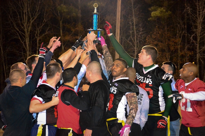 Football players from the 628th Civil Engineer Squadron celebrate after winning Intramural Flag Football Championship, Jan. 17, 2014 at Joint Base Charleston – Air Base, S.C. CES beat the 628th Force Support Squadron 13-12 to win back-to-back championships. (U.S. Air Force photo/Staff Sgt. Anthony Hyatt)