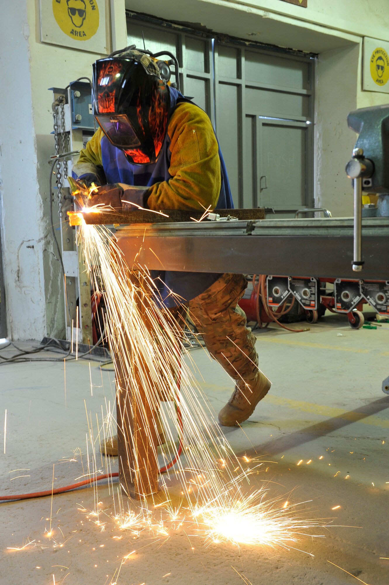 Gary Lum, a U.S. Air Force civilian, uses an acetylene torch to cut metal at the USFOR-A Garrison metals shop on Bagram Airfield, Afghanistan, Jan. 21, 2014. Lum is a native of Kaneohe, Hawaii, and deployed from Malmstrom Air Force Base, Mont.(U.S. Air Force photo by Senior Master Sgt. Gary J. Rihn/Released)