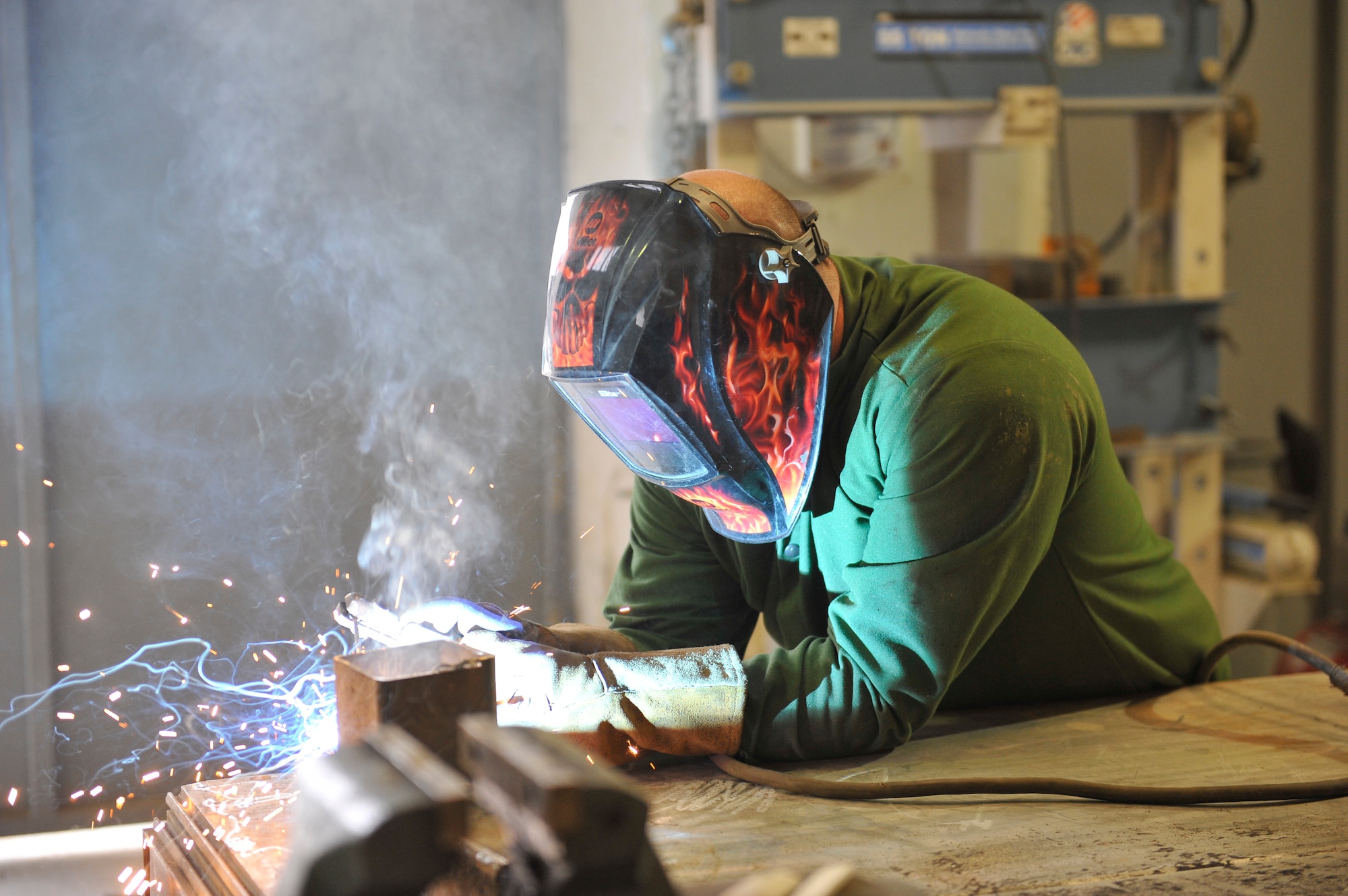 Terry Owens, a U.S. Air Force civilian, welds a bracket at the USFOR-A Garrison welding shop on Bagram Airfield, Afghanistan, Jan. 21, 2014. Owens, a native of Columbus, Ga., is deployed from Robins Air Force Base. (U.S. Air Force photo by Senior Master Sgt. Gary J. Rihn/Released)