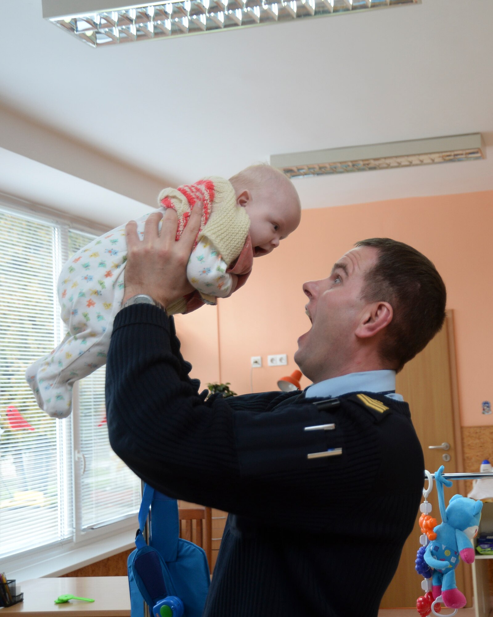 Sgt. Maj. Vytautas Urbelis, Lithuanian air force commander sergeant, plays with a child at the Šiauliai City Baby’s Orphanage in Lithuania, Jan. 9, 2014. Airmen volunteered during the NATO Baltic Air Policing mission to give back to the host community. (U.S. Air Force photo by Airman 1st Class Nigel Sandridge/Released)