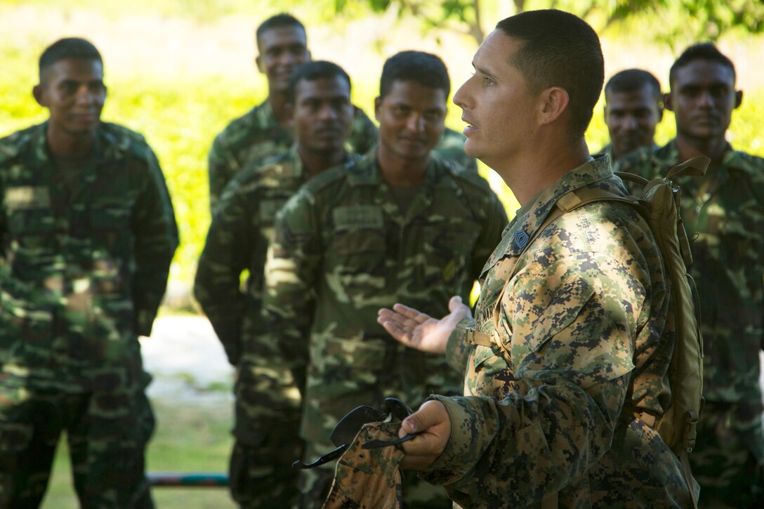 U.S. Marine Corps Master Sgt. John Martinez speaks with Maldivian marines at the beginning of a noncommissioned officer development program to promote professional military and cultural exchanges in Maafilaafushi, Maldives, Jan. 21, 2014. This training event also provides an opportunity for the forces to train in unfamiliar settings to gain experience with different tactics, techniques and procedures. Martinez is assigned to the Mobile Training Team Chief, U.S. Marine Corps Forces Pacific.