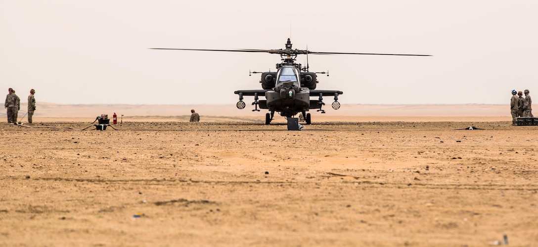 A U.S. Army AH-64 Apache helicopter idles during a forward arming and refueling point exercise near Camp Buehring, Kuwait, Jan. 15, 2014.