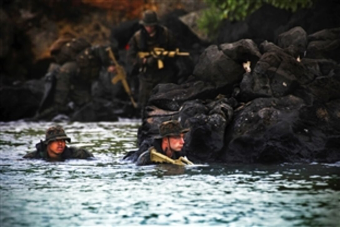 Marines conduct amphibious operations during Exercise Sandfisher on Marine Corps Base Hawaii, Jan. 17, 2014. The exercise provides an opportunity for the Okinawa-based Marines to train for underwater navigation, small boat operations, high-altitude high-opening parachuting, combatant diving and ground reconnaissance tactics. The Marines are assigned to the 3rd Marine Divisions 3rd Reconnaissance Battalion. 