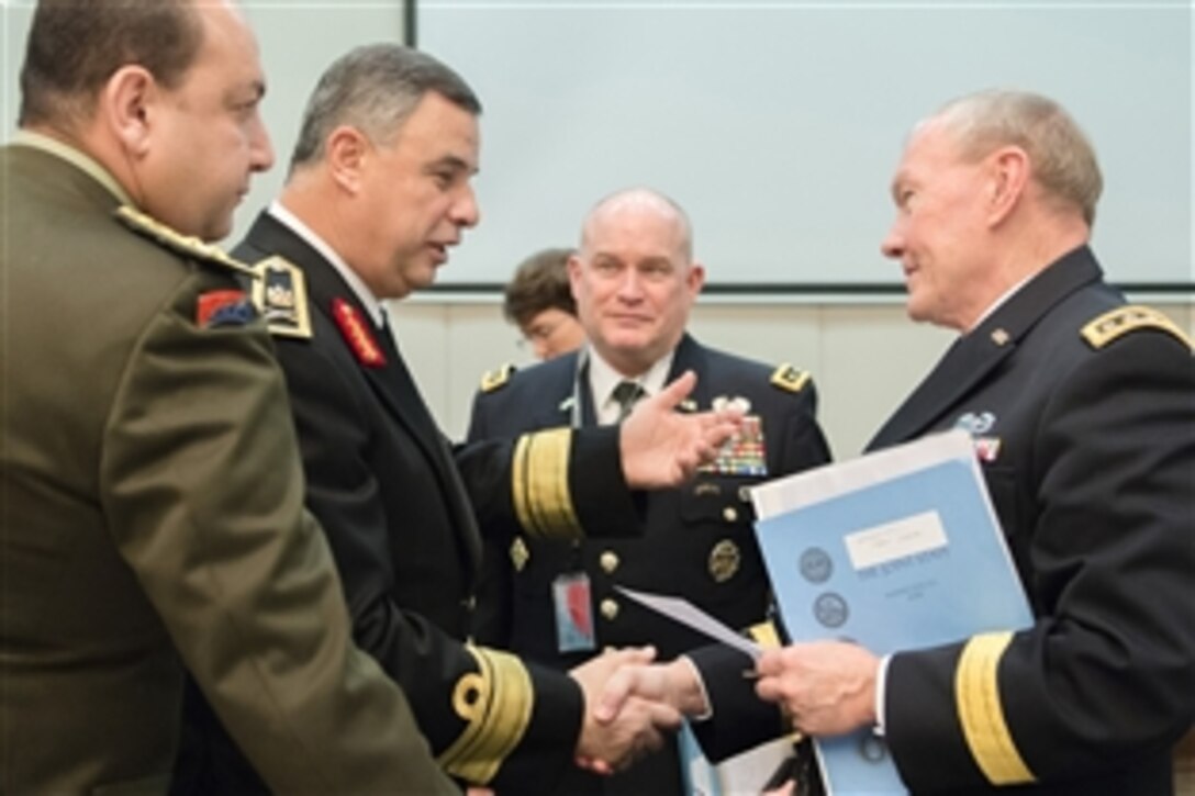 U.S. Army Gen. Martin E. Dempsey, chairman of the Joint Chiefs of Staff greets Egyptian Deputy Defense Chief Vice Adm. Ahmed Khaled while attending the 170th NATO Chiefs of Defense meeting at NATO headquarters in Brussels, Jan. 22, 2014. 