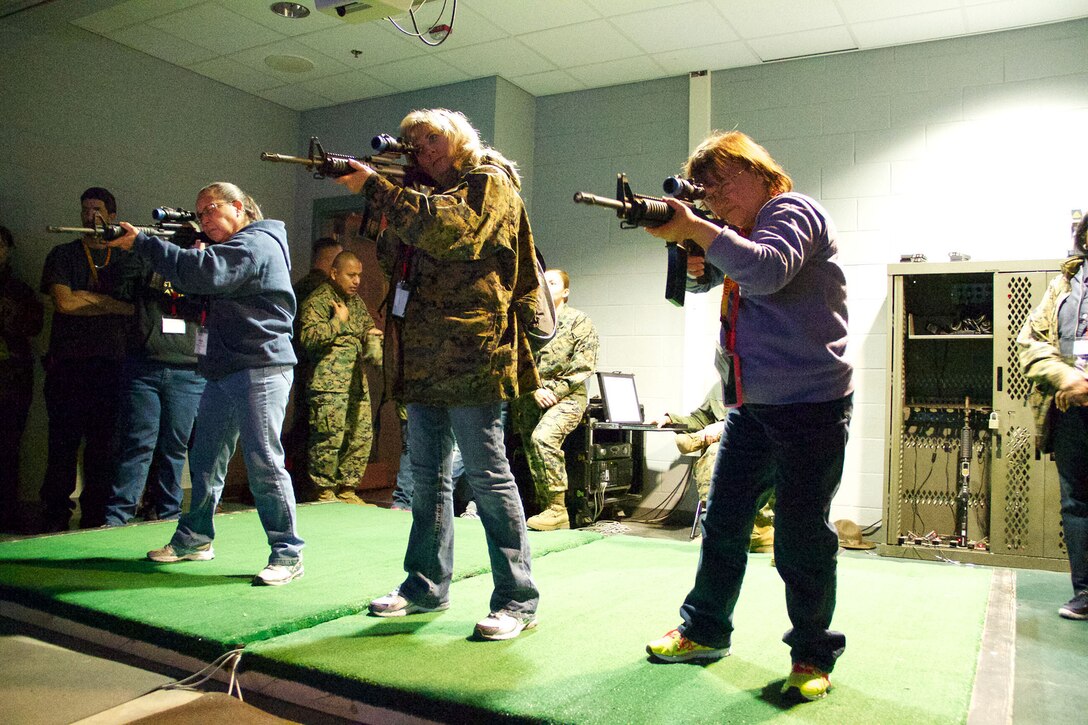 A Group of high school educators from south Florida fire a simulated M4 – A4 carbine during a visit to Marine Corps Recruit Depot Parris Island, S.C., Jan. 15, 2014. Each year, hundreds of high school educators participate in the Marine Corps’ Educator’s Workshop to get a deeper understanding of how the Corps makes Marines. 