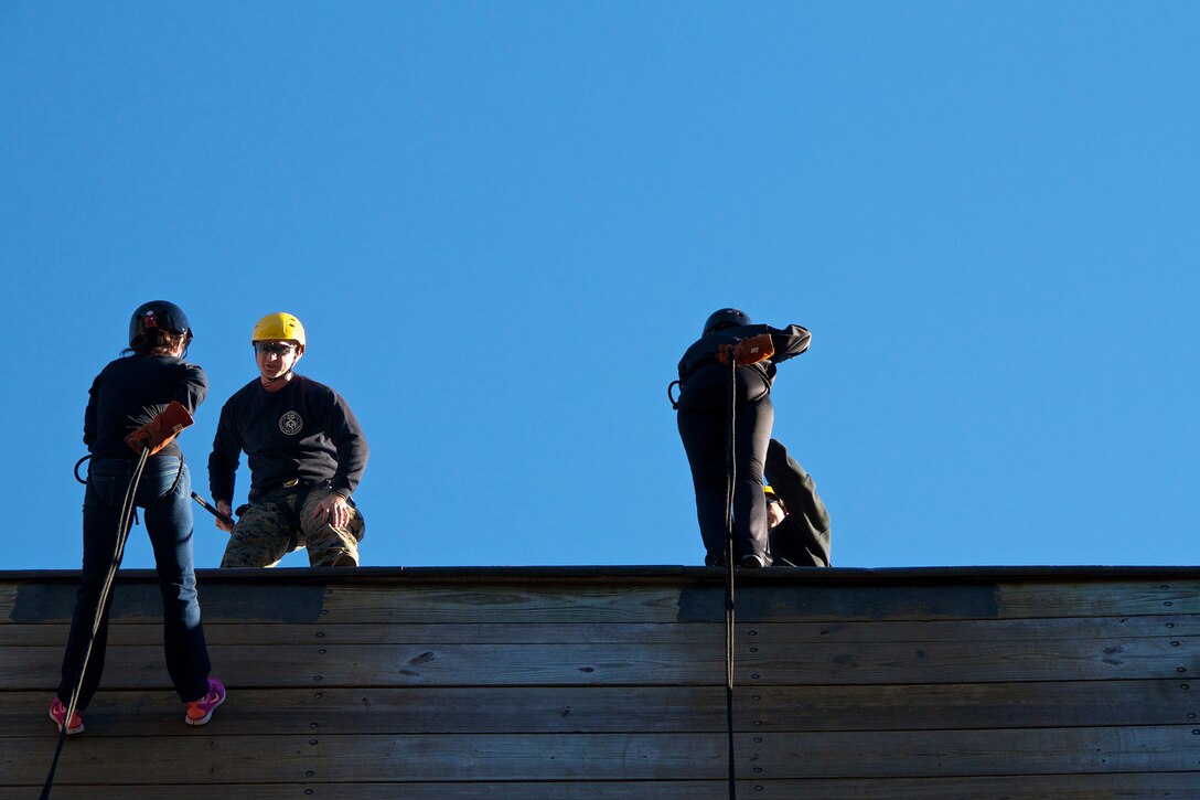 High school educators from south Florida and Puerto Rico rappel during an educator’s workshop aboard Marine Corps Recruit Depot Parris Island, S.C., Jan. 16, 2014. Each year, hundreds of high school educators participate in the Marine Corps’ Educator’s Workshop to get a deeper understanding of how the Corps makes Marines.  