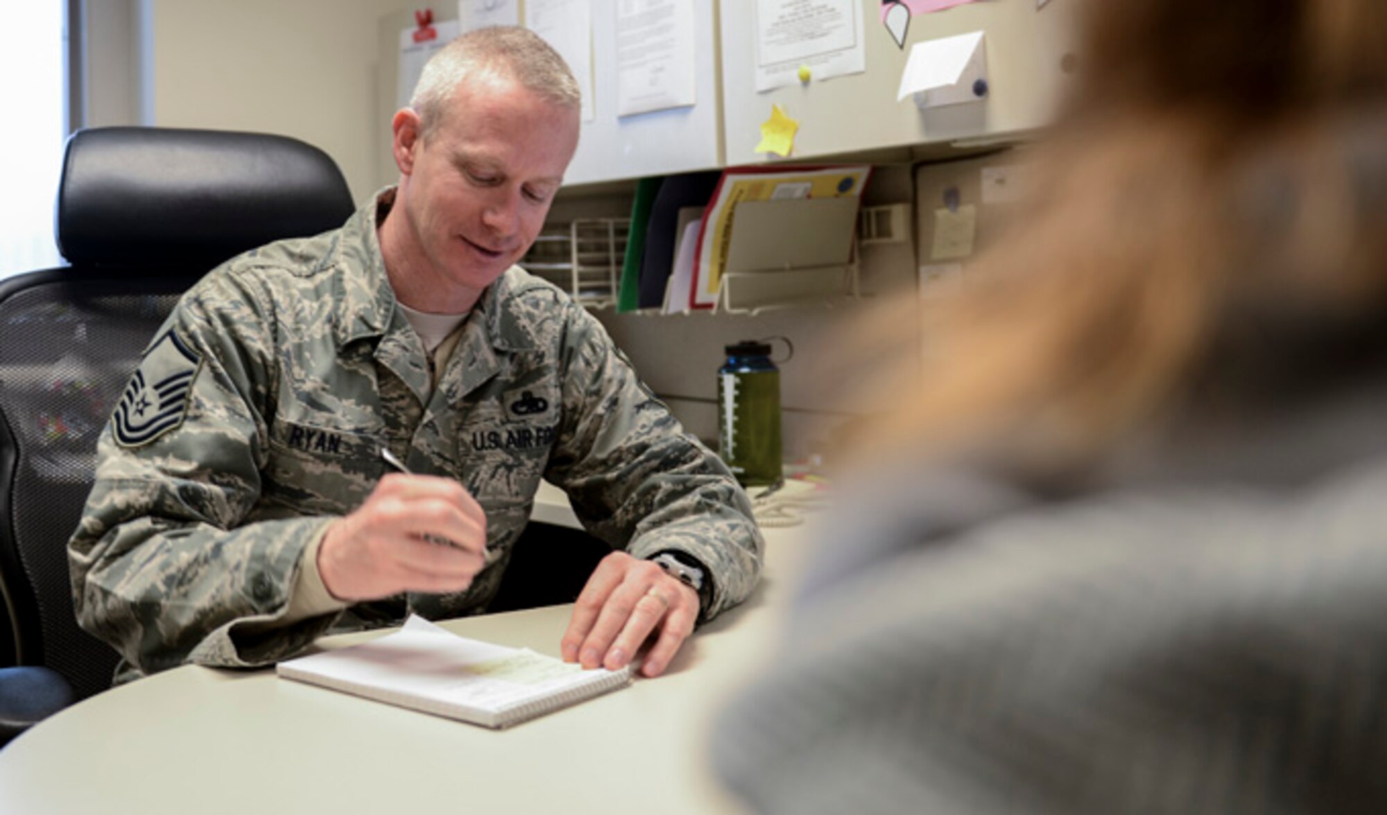 Master Sgt. Phil Ryan takes notes in his office, Jan. 17, 2014, at Joint Base Lewis-McChord, Wash. Ryan is the 62nd Airlift Wing inspector general complaint resolution superintendent and a reserve police officer with the Yelm Police Department in Yelm, Wash. In his Air Force job, Ryan often applies the investigation skills he has learned as a police officer. (U.S. Air Force photo/Tech. Sgt. Sean Tobin)