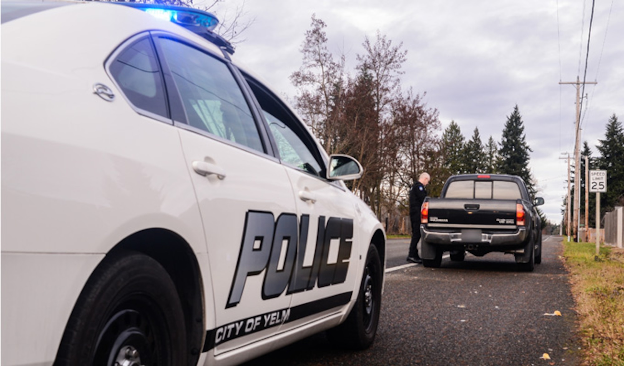 Master Sgt. Phil Ryan, collects a driver's information following a traffic stop, Dec. 14, 2013, in Yelm, Wash. Ryan is the 62nd Airlift Wing Inspector General complaint resolution superintendent, also a reserve police officer at the Yelm Police Department As a sworn peace officer, Ryan volunteers his free time with police department. (U.S. Air Force photo/Tech. Sgt. Sean Tobin)