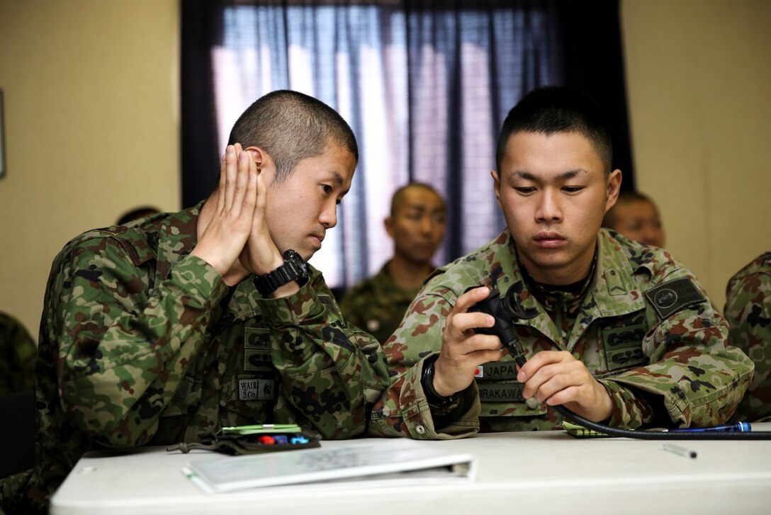 Soldiers from the Japan Ground Self-Defense Force inspect the Supplemental Egress Breathing Device while conducting Under Water Egress training during Exercise Iron Fist 2014 aboard Camp Pendleton, Calif., Jan. 22, 2014. Iron Fist 2014 is an amphibious exercise that brings together Marines and sailors from the 15th Marine Expeditionary Unit, other I Marine Expeditionary Force units, and soldiers from the JGSDF, to promote military interoperability and hone individual and small-unit skills through challenging, complex and realistic training. (U.S. Marine Corps photo by Cpl. Emmanuel Ramos/Released)