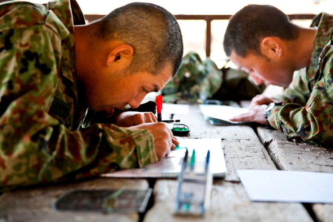 Soldiers with the Japan Ground Self-Defense Force plot coordinate points prior to land navigation training during Exercise Iron Fist 2014 aboard Camp Pendleton, Calif., Jan. 22, 2014. Iron Fist is an amphibious exercise that brings together Marines and sailors from the 15th Marine Expeditionary Unit, other I Marine Expeditionary Force units, and soldiers from the JGSDF, to promote military interoperability and hone individual and small-unit skills through challenging, complex and realistic training. (U.S. Marine Corps photo by Lance Cpl. Ricardo Hurtado/Released)