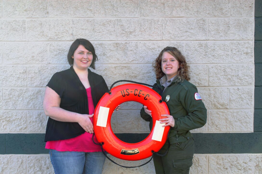 Direct Care representative and staff member Monica Chowning (Left) and  Lake Cumberland Park Ranger Ashley Glyn-Jones display a life ring preserver, which is one of the most common and most used throwable liffe saving devices. 