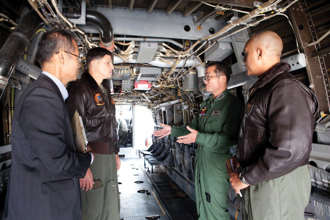 Japan Air Self-Defense Lt. Gen. Yoshiyuki Sugiyama, center right, discusses the capabilities of the MV-22B Osprey tiltrotor aircraft Jan. 19 with U.S. Marine Corps Lt. Col. Larry G. Brown, center left, and U.S. Marine Corps Col. Brain W. Cavanaugh, right, during a visit to Marine Corps Air Station Futenma. Sugiyama is the commanding general of the JASDF’s Southwestern Composite Air Division. Cavanaugh is the commanding officer of Marine Aircraft Group 36, 1st Marine Aircraft Wing, III Marine Expeditionary Force. Brown is the commanding officer of Marine Medium Tiltrotor Squadron 262, MAG-36. 
