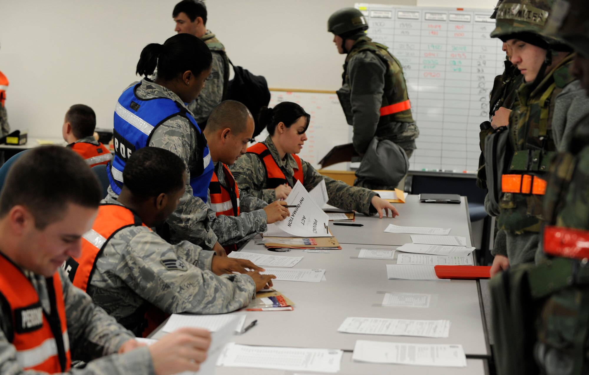 Members from the 35th Force Support and Comptroller Squadrons inprocess Airmen through the personnel deployment function line during phase one of an operational readiness exercise at Misawa Air Base, Japan, Jan. 23, 2014.  During this process, individual gear is issued and files are reviewed, ensuring Airmen are prepared and cleared for deployment.  (U.S. Air Force photo/Airman 1st Class Patrick S. Ciccarone)