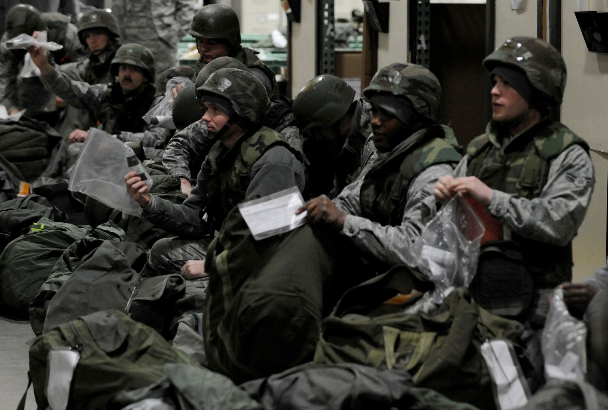 Airmen from the 35th Fighter Wing process a personnel deployment function line during phase one of an operational readiness exercise at Misawa Air Base, Japan, Jan. 23, 2014. During the line, Airmen receive and inventory their equipment bags before the bags are palletized by members of the 35th Logistics Readiness Squadron. (U.S. Air Force photo/Airman 1st Class Patrick S. Ciccarone)