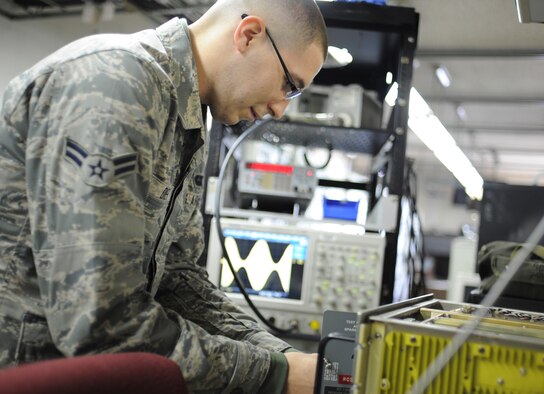 YOKOTA AIR BASE, Japan -- Airman 1st Class Montana Diehl, 374th Communications Squadron airfield systems technician, performs a maintenance inspection on a transceiver radio. These inspections are done periodically to prevent things from breaking inside the radio, as well as to provide the best audio signal possible and to prevent problems found from getting worse. (U.S. Air Force photo by Staff Sgt. Andrea Salazar/Released)