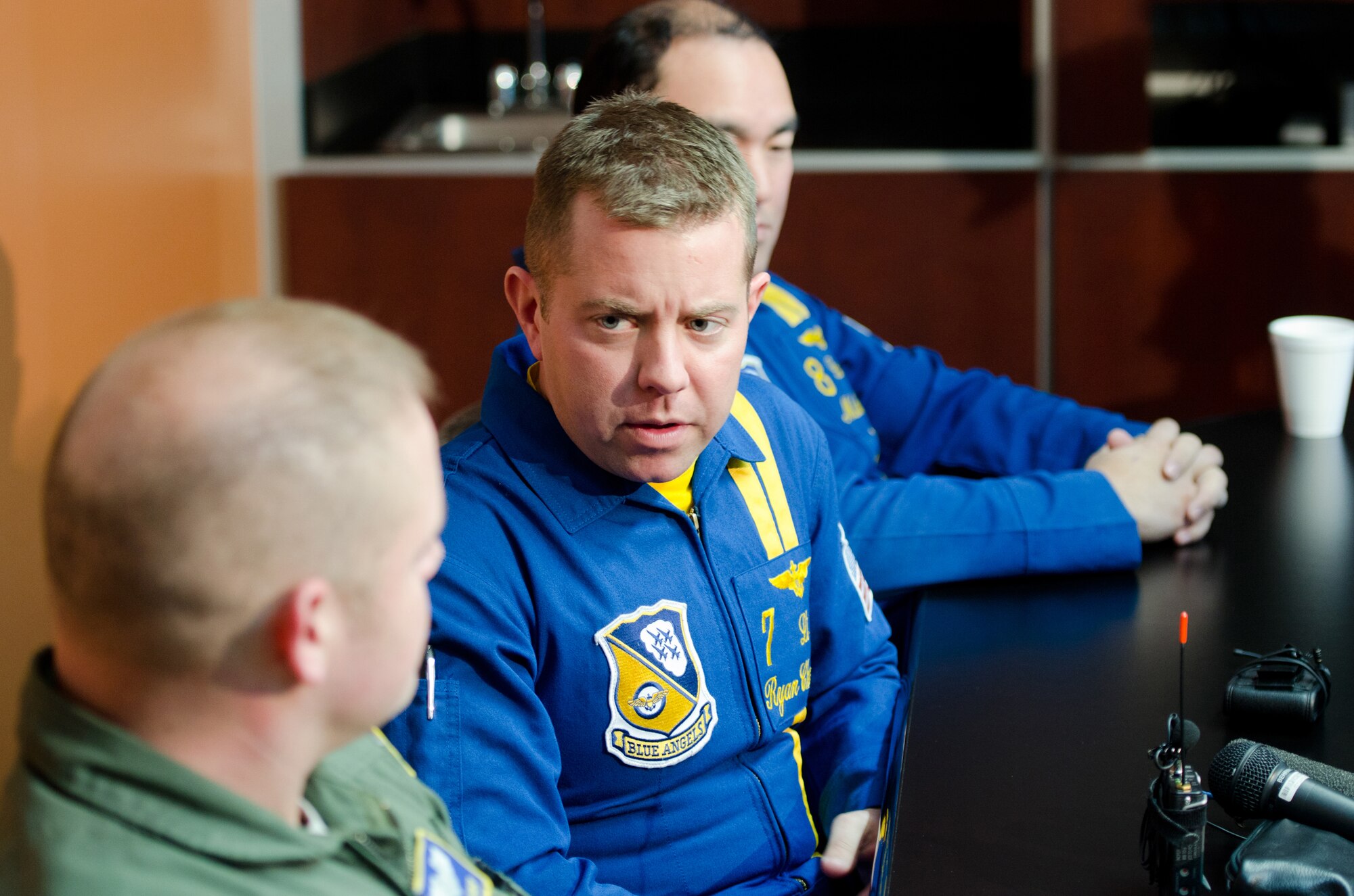 U.S. Navy Lt. Ryan Chamberlain, a Blue Angels F/A-18 pilot and air show narrator, talks with Capt. Josh Ketterer, air show coordinator for the Kentucky Air National Guard, during a press conference Jan. 23, 2014, at Louisville International Airport in Louisville, Ky., promoting the 2014 Thunder Over Louisville air show. The Blue Angels will be the marquee attraction at this year’s show, while the Kentucky Air Guard will provide hundreds of hours of support to military aircraft. (U.S. Air National Guard photo by Master Sgt. Phil Speck)