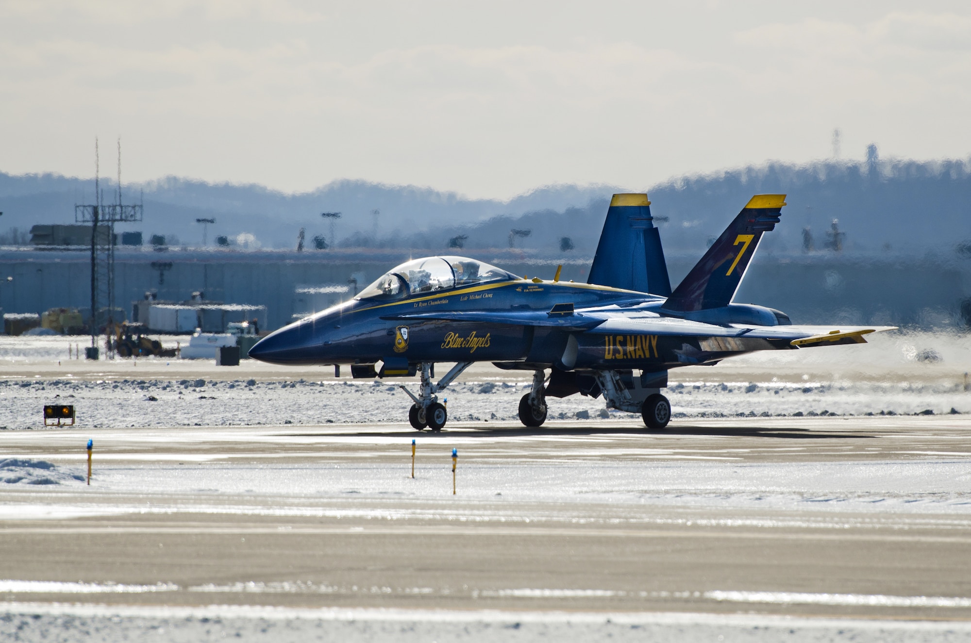 A U.S. Navy Blue Angels F/A-18 Hornet fighter jet and two aircrew members arrive at Louisville International Airport in Louisville, Ky., on Jan. 23, 2014, for a planning session at the Kentucky Air National Guard Base in preparation for the Thunder Over Louisville air show, scheduled for April 12. The Kentucky Air Guard is providing hundreds of hours of support to military aircraft flying in the show. (U.S. Air National Guard photo by Master Sgt. Phil Speck)
