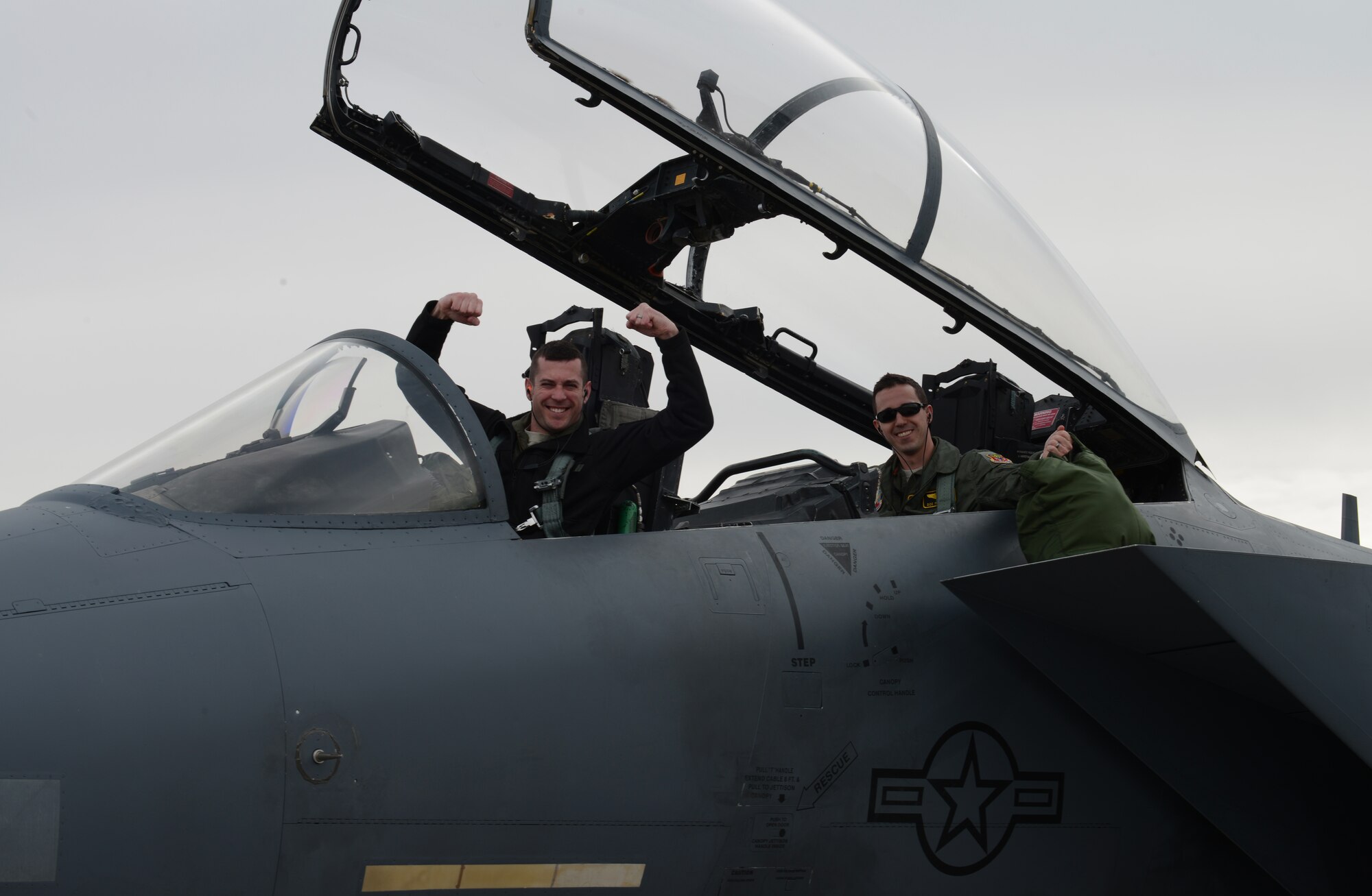 Capt. Benjamin Hoffman, 391st Fighter Squadron training officer, and 1st Lt. Matthew Martinez, 391st FS weapons system officer, cheer after landing their F-15E Strike Eagle Jan. 23, 2013, at Nellis Air Force Base, Nev. Members of the 366th Fighter Wing from Mountain Home Air Force Base, Idaho, waited more than three hours due to foggy conditions before being allowed to set out for Nellis AFB to participate in the combat exercise Red Flag 14-1. (U.S. Air Force photo by Senior Airman Benjamin Sutton/Released)