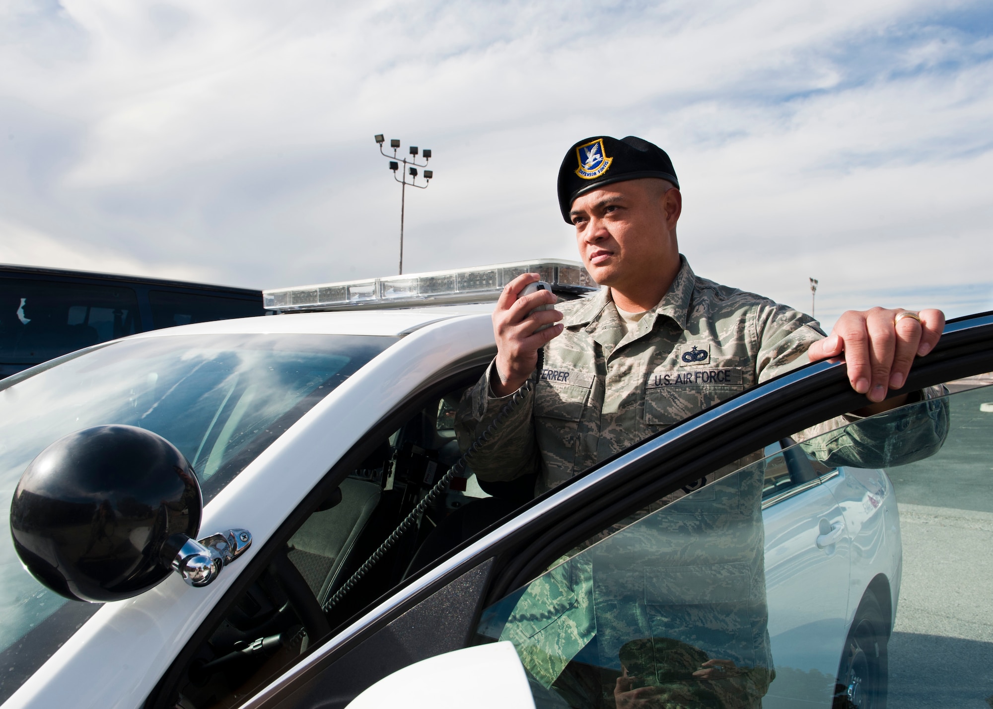 U.S. Air Force Staff Sgt. Peter Ferrer, 99th Security Forces Squadron patrolman, makes a call from his patrol car radio Jan. 21, 2014, at Nellis Air Force Base, Nev. Ferrer was the Diamond Sharp Award recipient for December 2013. Some of Ferrer’s accomplishments include leading an Airman to the Security Forces Top Defender Award, training a 99th Air Base Wing Life of a Warrior team garnering a second place finish, completing three credit hours toward his Bachelor of Science degree in Criminal Justice and holding the American Flag during the National Anthem at the Royal Purple Las Vegas Bowl. (U.S. Air Force photo by Airman 1st Class Thomas Spangler)