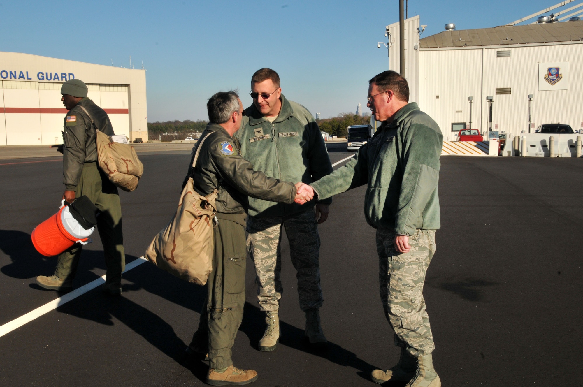 U.S. Air Force Col. Quincy Huneycutt, Vice Wing Commander, 145th Airlift Wing, congratulates Senior Master Sgt. Philip H. Smith after Smith completed his final flight onboard a 145th AW C-130 Hercules aircraft.  He served more than 35 years in the military, 24 of those years were as a tactic loadmaster for the 156th Airlift Squadron.  Smith’s fini flight was held at the North Carolina Air National Guard base, Charlotte-Douglas Intl. airport, January 16, 2014 in honor of his retirement.  (Air National Guard photo by Master Sgt. Patricia F. Moran, 145th Public Affairs/Released)
