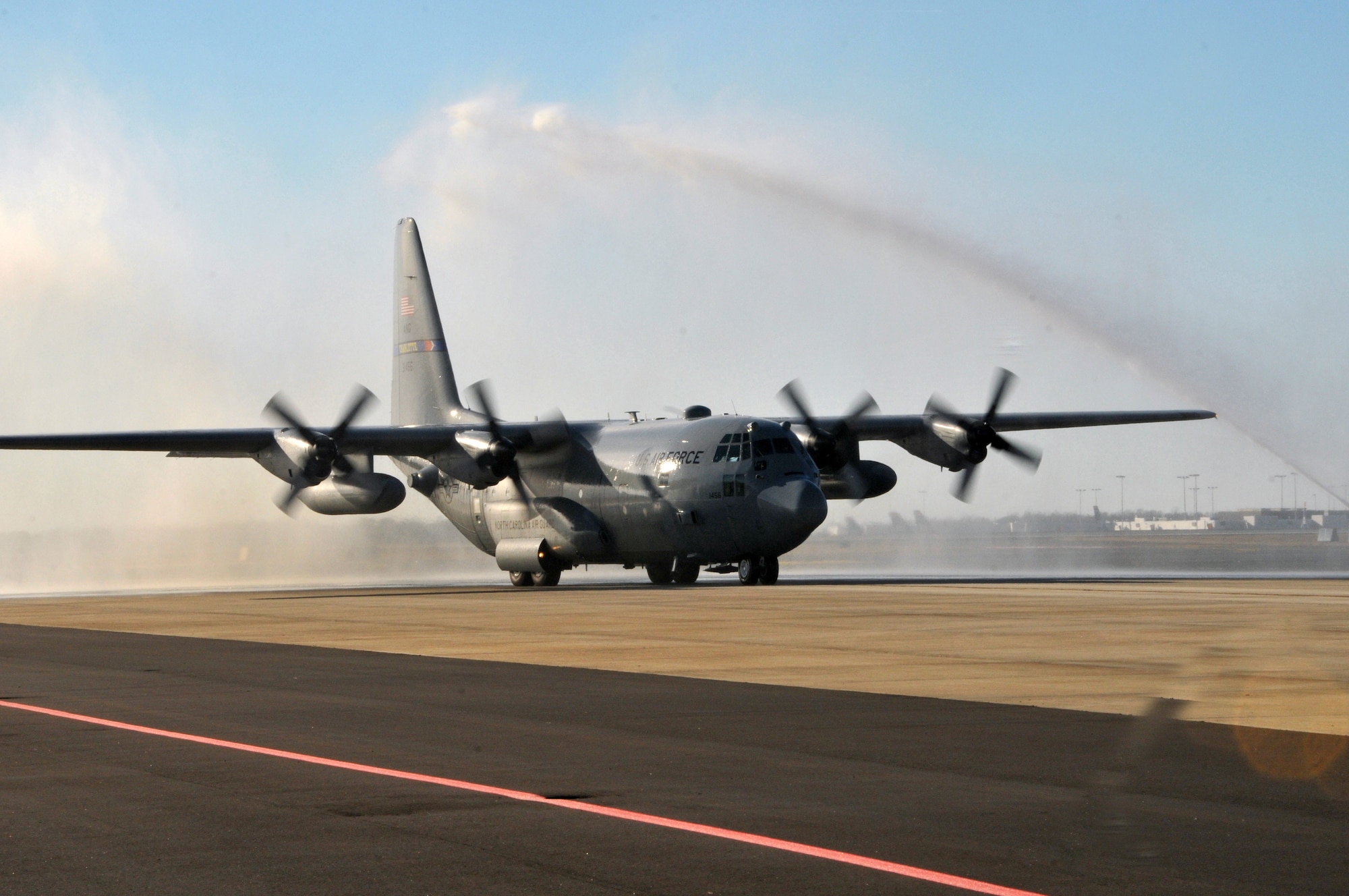 A 145th Airlift Wing C-130 Hercules aircraft made its way beneath an arc of water spraying from two fire trucks as it taxied to its parking spot.  In a tradition nearly as old as military aviation itself, Senior Master Sgt. Philip Smith completed his final “fini” flight at the North Carolina Air National Guard base on January 16, 2014, symbolizing the end of 35 years of honorable military service.  (Air National Guard photo by Master Sgt. Patricia F. Moran, 145th Public Affairs/Released)