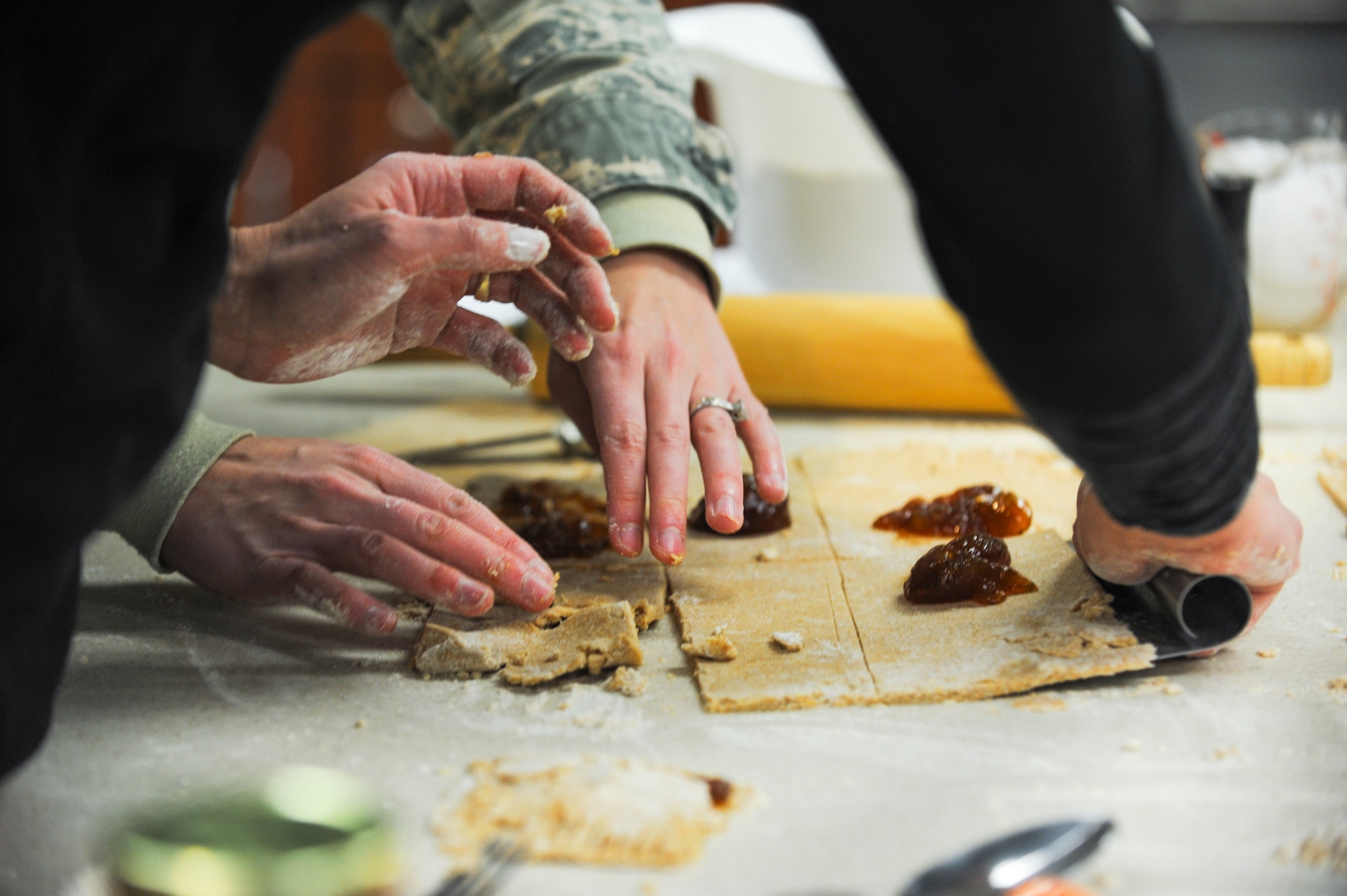 Staff Sgt. Tonya Woosley, Air Reserve Personnel Center, shapes dough into pastries with Angela Peralta, Buckley Health and Wellness Center registered dietitian, during a healthy cooking class Jan. 17, 2014, at the HAWC on Buckley Air Force Base, Colo. Woosley was one of several Team Buckley members who attended the class taught by Peralta. (U.S. Air Force photo by Airman Emily Amyotte/Released)