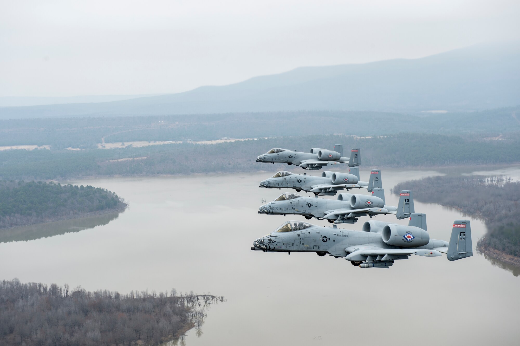 Col. Mark Anderson (Tail No. 188), 188th Fighter Wing commander; Maj. Doug Davis (Tail No. 639), 188th Detachment 1 commander; Col. Brian Burger (Tail No. 613), 188th Operations Group commander; and Capt. Wade Hendrickson (Tail No. 638) conduct a training mission Dec. 30, 2013, over Razorback Range, located at Fort Chaffee Maneuver Training Center, Ark. The photos were captured from a 189th Airlift Wing C-130 Hercules. The sortie was one of the last four-ship training missions that will be conducted at the 188th. The wing is currently transitioning from a fighter mission to an Intelligence, Surveillance and Reconnaissance/remotely piloted aircraft (MQ-9 Reaper) mission that will also feature a space-focused targeting squadron. The 188th has divested two A-10C Thunderbolt II “Warthogs” per month since September 2013. The last Warthog is slated to leave the 188th in June 2014. The 188th has flown A-10s since April 2007 and has had assigned aircraft on site since 1953. June will mark the first time in unit’s 60-year history that no assigned military aircraft will be parked on the flightline at Ebbing Air National Guard Base, Fort Smith, Ark. (U.S. Air Force photo by Senior Airman Matthew Bruch)