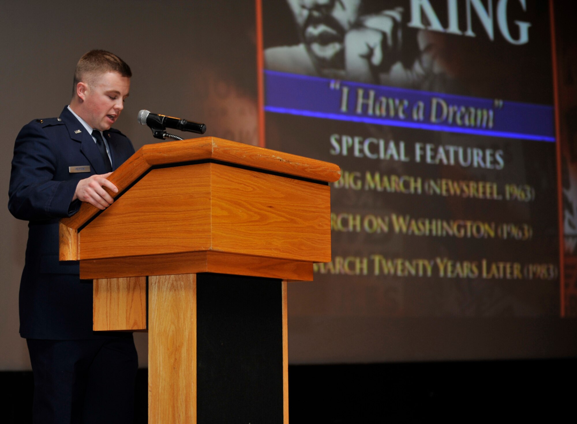 Air Force 2nd Lt. Erik Peyton, 673d Logistics Readiness Squadron readiness flight commander, speaks to military members during the Martin Luther King Day Jr. observance at the Talkeetna Theater on Jan. 22. During the presentation, members of audience read quotes from King’s speeches from his time as one of the leaders of the civil rights movement. (U.S. Air Force photo/Airman 1st Class Tammie Ramsouer)