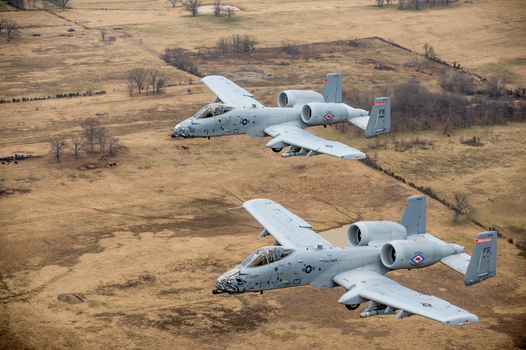 Col. Mark Anderson (Tail No. 188), 188th Fighter Wing commander, and Maj. Doug Davis (Tail No. 639), 188th Detachment 1 commander, conduct a training mission Dec. 30, 2013, over Razorback Range, located at Fort Chaffee Maneuver Training Center, Ark. The photos were captured from a 189th Airlift Wing C-130 Hercules. The sortie was one of the last four-ship training missions that will be conducted at the 188th. The wing is currently transitioning from a fighter mission to an Intelligence, Surveillance and Reconnaissance/remotely piloted aircraft (MQ-9 Reaper) mission that will also feature a space-focused targeting squadron. The 188th has divested two A-10C Thunderbolt II “Warthogs” per month since September 2013. The last Warthog is slated to leave the 188th in June 2014. The 188th has flown A-10s since April 2007 and has had assigned aircraft on site since 1953. June will mark the first time in unit’s 60-year history that no assigned military aircraft will be parked on the flightline at Ebbing Air National Guard Base, Fort Smith, Ark. (U.S. Air Force photo by Senior Airman Matthew Bruch)