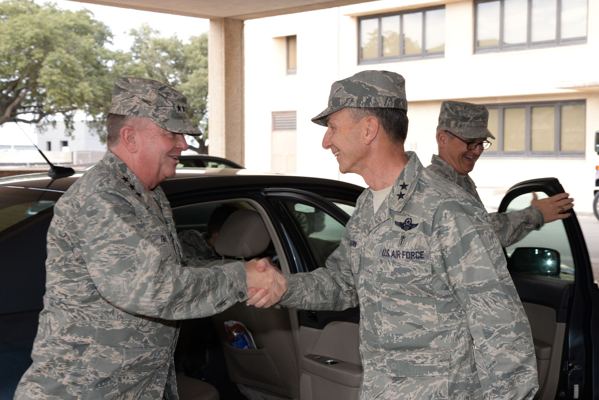 Lt. Gen. Thomas W. Travis, U.S. Air Force Surgeon General, is greeted by Maj. Gen. Byron C. Hepburn, 59th Medical Wing commander, and deputy director of the San Antonio Military Health System, upon his arrival at the Wilford Hall Ambulatory Surgical Center Jan. 22, 2014, on Joint Base San Antonio-Lackland, Texas. During his visit to San Antonio, Travis toured the WHASC and the Reid Clinic, which provides health care for Air Force trainees, as well as the San Antonio Military Medical Center on nearby JBSA-Fort Sam Houston. All Air Force and Army medical facilities in the city are integrated partners in the San Antonio Military Health System. (U.S. Air Force photo/Staff Sgt. Christopher Carwile)