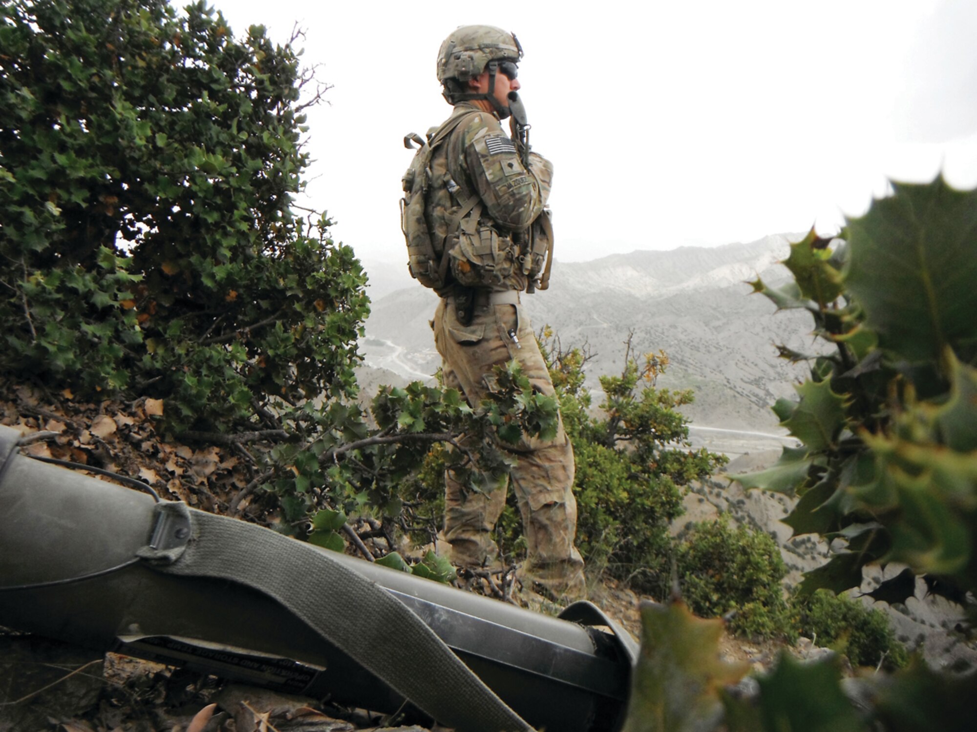 Sgt. Oscar Vazquez, a cavalry scout with the 1st Squadron, 40th Cavalry Regiment, 4th Infantry Brigade Combat Team (Airborne), 25th Infantry Division, looks over a valley during a combat patrol in May of 2012 near Combat Outpost Wilderness in the Paktya Province, Afghanistan. Vasquez, originally born in Mexico, graduated high school in Phoenix, earned a bachelor’s degree at Arizona State University, joined the Army and is now a U.S. citizen. (Courtesy Photo)