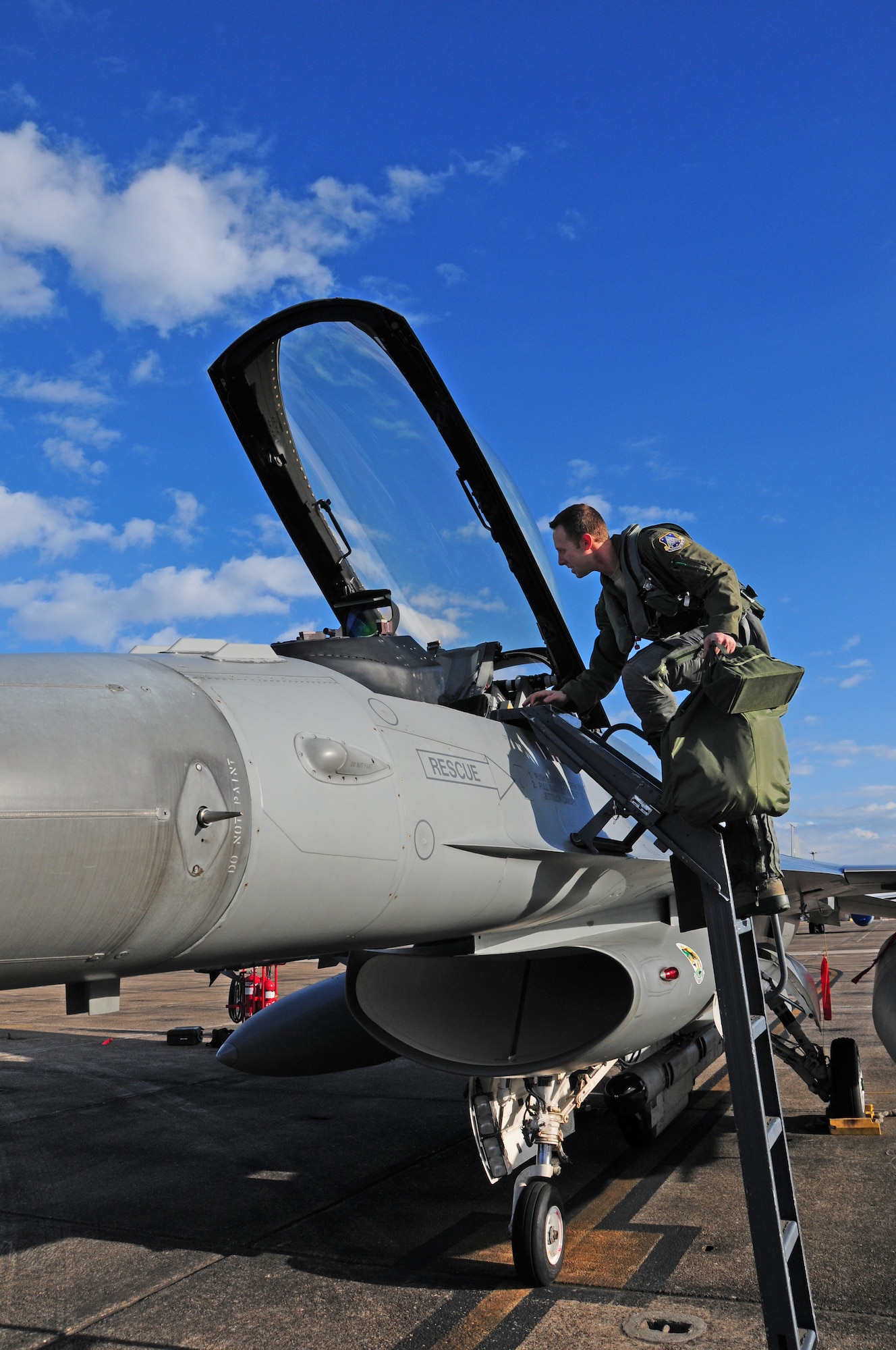 180th Fighter Wing F-16 Fighting Falcon pilot Capt. Jerad Ames climbs into the cockpit before a training flight at Joint Reserve Base New Orleans, New Orleans, La.  Jan. 16, 2014.  The 180th Fighter Wing is currently participating in a training exercise with F-15 Screaming Eagles from the 159th FW, New Orleans Air National Guard.  The purpose of this training is to aid pilots in maintaining familiarity with capabilities of different fighter aircraft.  The 180th’s F-16s are a multi-role aircraft whereas the F-15s conduct mainly air-to-air missions. (Ohio Air National Guard photo by Staff Sgt. Amber Williams/Released)