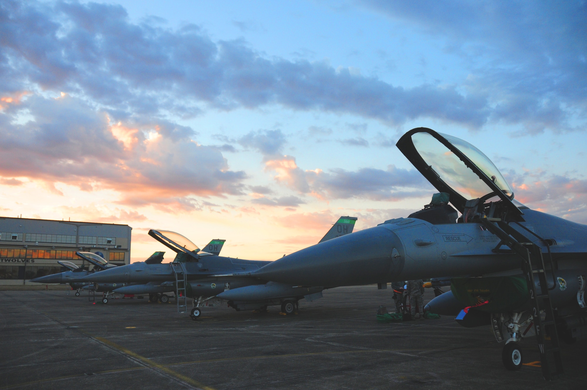 F-16s from the 180th Fighter Wing sit on the flight line during sunrise at the Joint Reserve Base New Orleans, New Orleans, La., Jan. 16, 2014. The 180th Fighter Wing is currently participating in a training exercise with F-15 Screaming Eagles from the 159th FW, New Orleans Air National Guard.  The purpose of this training is to aid pilots in maintaining familiarity with capabilities of different fighter aircraft.  The 180th’s F-16s are a multi-role aircraft whereas the F-15s conduct mainly air-to-air missions. (Ohio Air National Guard photo by Staff Sgt. Amber Williams/Released)