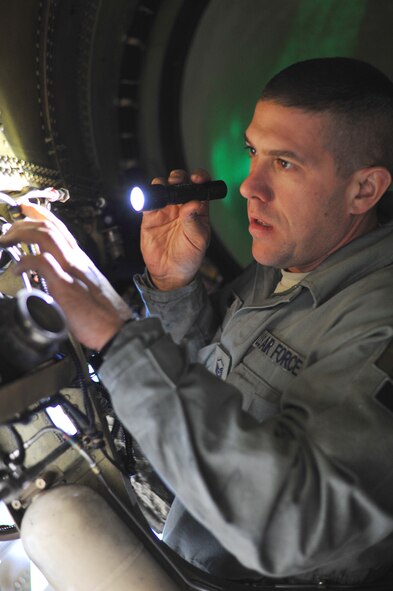 Master Sgt. Matthew Stamm, a crew chief from the 180th Fighter Wing, examines the inside of an F-16 Fighting Falcon at Joint Reserve Base New Orleans, New Orleans, La., Jan. 16, 2014. The 180th Fighter Wing is currently participating in a training exercise with F-15 Screaming Eagles from the 159th FW, New Orleans Air National Guard.  The purpose of this training is to aid pilots in maintaining familiarity with capabilities of different fighter aircraft.  The 180th’s F-16s are a multi-role aircraft whereas the F-15s conduct mainly air-to-air missions. (Ohio Air National Guard photo by Staff Sgt. Amber Williams/Released)