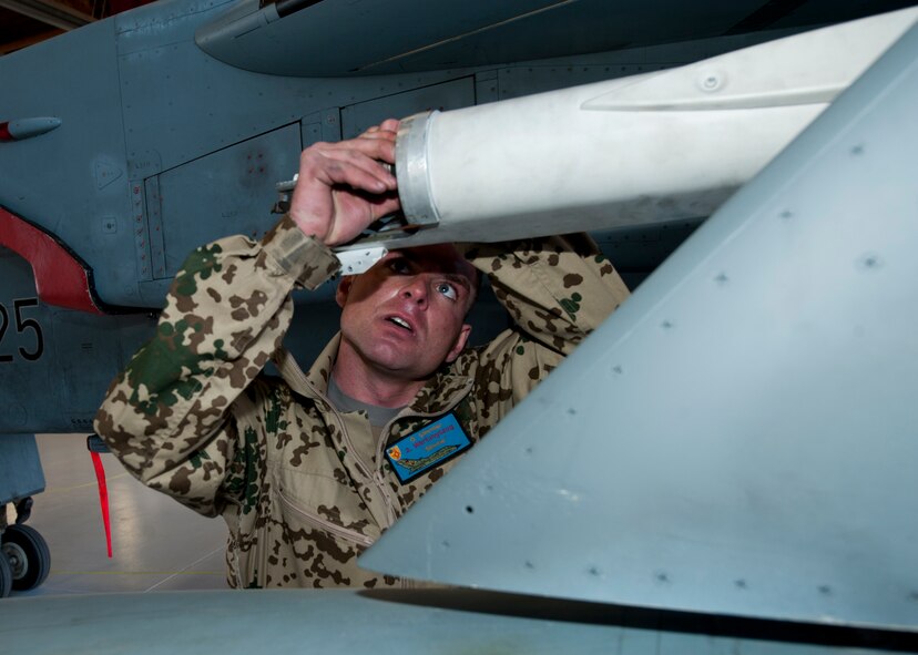 Staff Sgt. Oliver Simmler, German Air Force Flying Training Center crew chief, prepares an inert missile meant for a Tornado jet during a quarterly load crew competition at Holloman Air Force Base, N.M., Jan. 17. The GAF competed in the load crew competition to have their skills evaluated alongside the F-22 Raptor and MQ-9 Reaper load crews. For the competition, points are awarded during the weapons loading, tool kit inspection and uniform inspection. (U.S. Air Force photo by Senior Airman Daniel Liddicoet/Released)