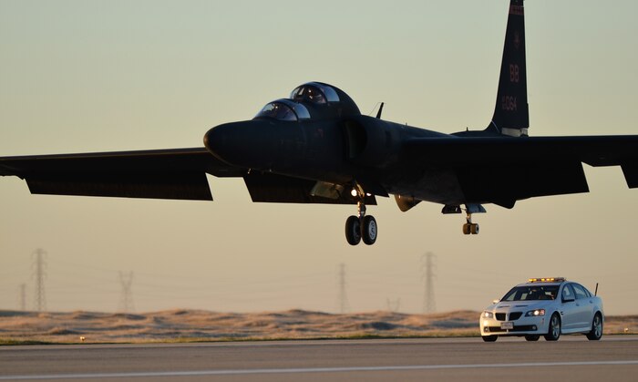 A mobile chase car pursues a TU-2S Dragon Lady at Beale Air Force Base, Calif., Jan. 22, 2014. Mobile chase cars accelerate to speeds more than 100 mph to guide the aircraft during takeoffs and landings. (U.S. Air Force photo by Airman 1st Class Bobby Cummings/Released) 