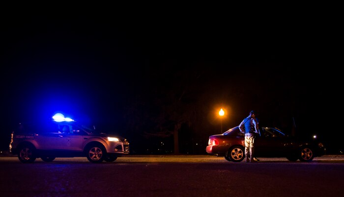 Staff Sgt. Kevin Smith, 628th Security Forces Squadron patrolman, and Airman 1st Class Trey Weston, 628th SFS entry controller to search, approach a motorist they suspect was speeding while they were conducting  a radar check point Dec. 22, 2013, at Joint Base Charleston – Air Base, S.C. 628th SFS patrolmen write tickets for speeding, parking violations and other motor vehicle violations on the Air Base and Weapons Station. (U.S. Air Force photo/ Senior Airman Dennis Sloan)