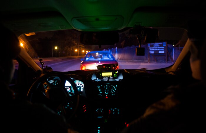 Staff Sgt. Kevin Smith, 628th Security Forces Squadron patrolman, and Airman 1st Class Trey Weston, 628th SFS entry controller to search, stop a motorist suspected of speeding while conducting a radar check point Dec. 22, 2013, at Joint Base Charleston – Air Base, S.C. 628th SFS patrolmen write tickets for speeding, parking violations and other motor vehicle violations on the Air Base and Weapons Station.  (U.S. Air Force photo/ Senior Airman Dennis Sloan)