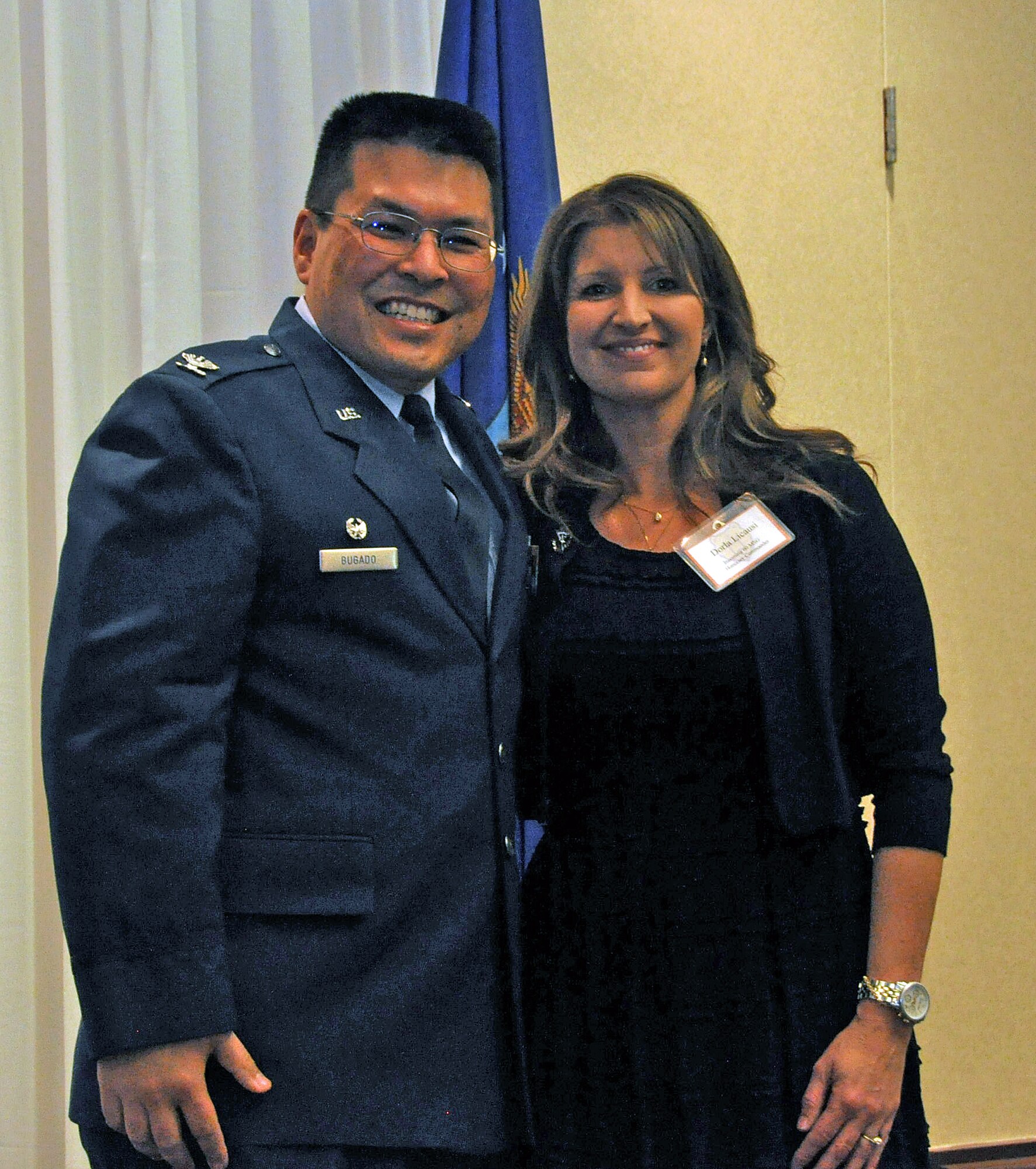 Col. Harold “Doug” Bugado, 60th Mission Support Group commander, poses with Dorla Licausi, Macy’s store manager, at the honorary commander induction ceremony Jan. 16 at the Delta Breeze Club at Travis Air Force Base, Calif. (U.S. Air Force photo/Senior Airman Madelyn Brown)