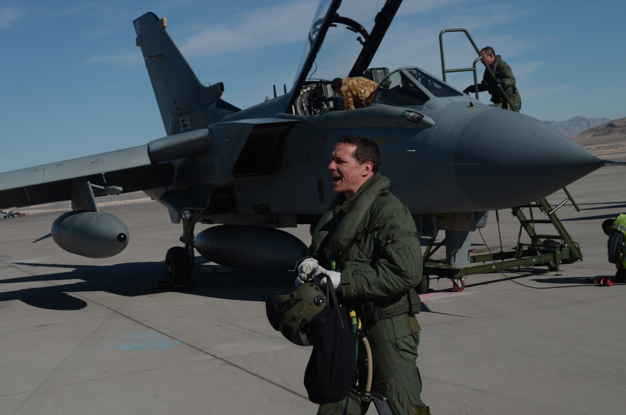 Wing Commander Chris Snaith, British Royal Air Force  IX (B) Squadron, yells hello to a ground crew member Jan. 22, 2013, at Nellis Air Force Base, Nev. Snaith who was educated at the Douglas Academy,Glasgow, Scotland, joined the Royal Air Force as a University Cadet in 1991. Snaith and his squadron are here to participate in the combat exercise Red Flag 14-1. (U.S. Air Force photo by Senior Airman Benjamin Sutton/Released)