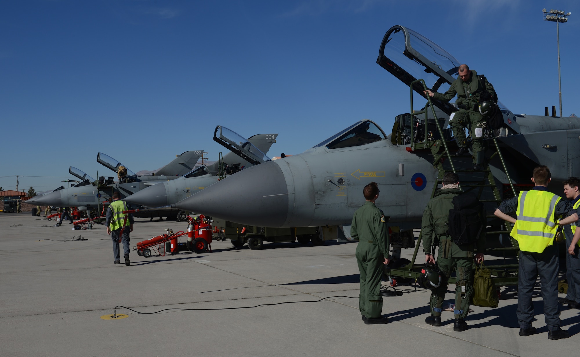 British Royal Air Force personnel recover multiple Tornado GR4s upon their arrival at Nellis Air Force Base, Nev., Jan. 22, 2013. More than 50 members of the IX (B) Squadron will be participating in the combat exercise Red Flag 14-1. (U.S. Air Force photo by Senior Airman Benjamin Sutton/Released)