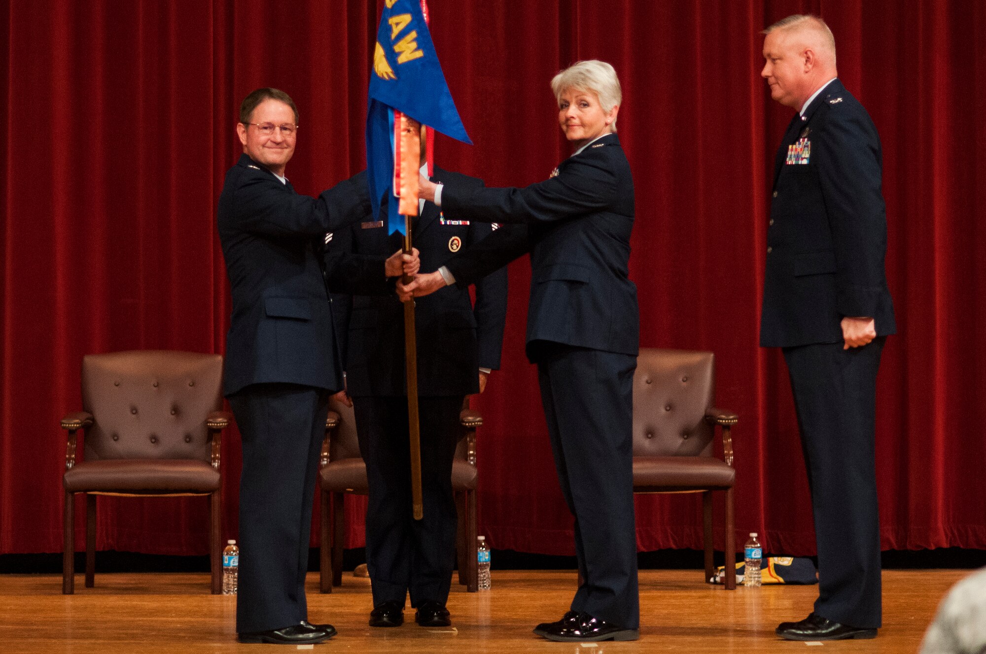 Col. Steve Eggensperger (from left), 189th Airlift Wing commander, passes the guidon to Col. Tamhra Hutchins-Frye, who took command of the 189th Mission Support Group from Col. Rob Ator at Little Rock Air Force Base, Ark. on Jan. 11, 2014. (U.S. Air Force photo by Senior Airman Ian Caple)