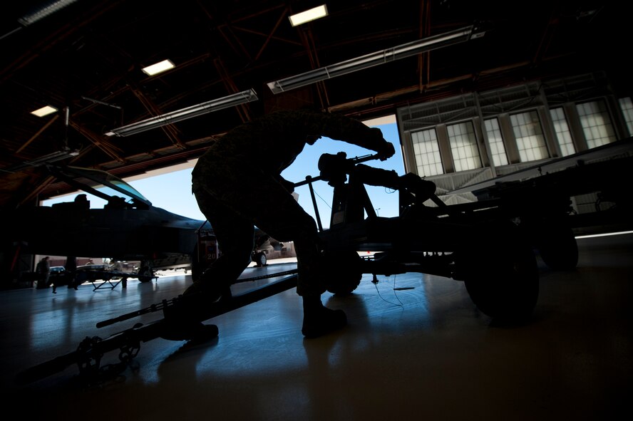 Senior Airman Thomas Lahut from the 849th Aircraft Maintenance Squadron, prepares to load an inert missile onto an MQ-9 Reaper during a quarterly load-crew competition at Holloman Air Force Base, N.M., Jan. 17. The MQ-9 load crew competed in the competition to have their skills evaluated alongside the F-22 Raptor and German Air Force load crews. For the competition, points are awarded during the weapons-loading, tool kit inspection and uniform inspection. (U.S. Air Force photo by Airman 1st Class Aaron Montoya / Released)